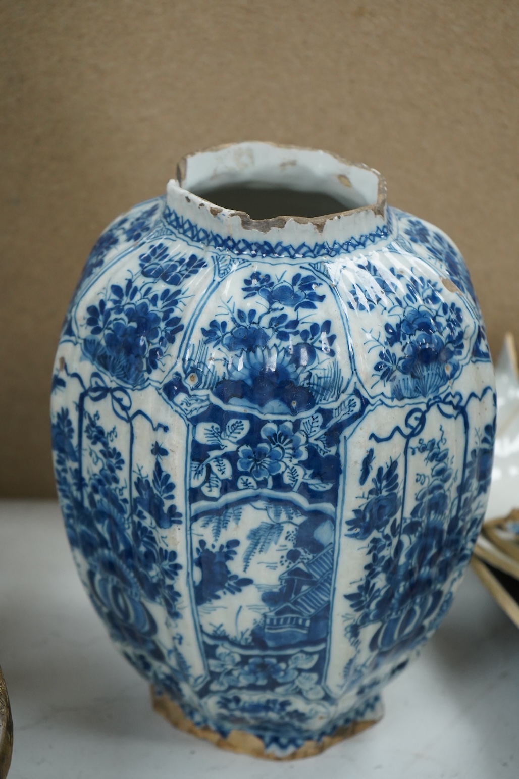 A late 17th century Delft faceted blue and white vase, by Lambartus van Eenhorn, and another broken similar, 29cm high (a.f.)